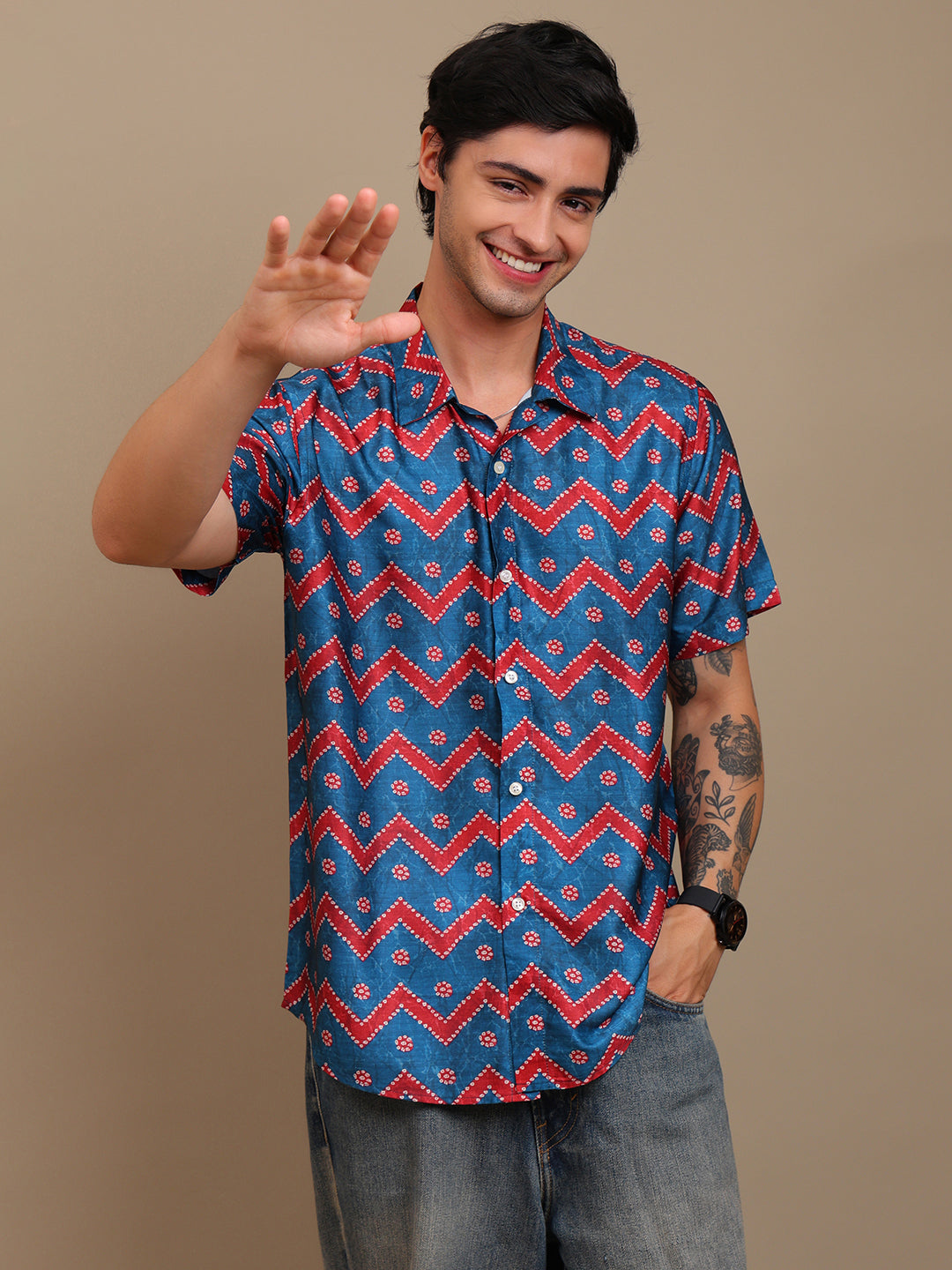 Man wearing a blue and red patterned shirt against a beige background