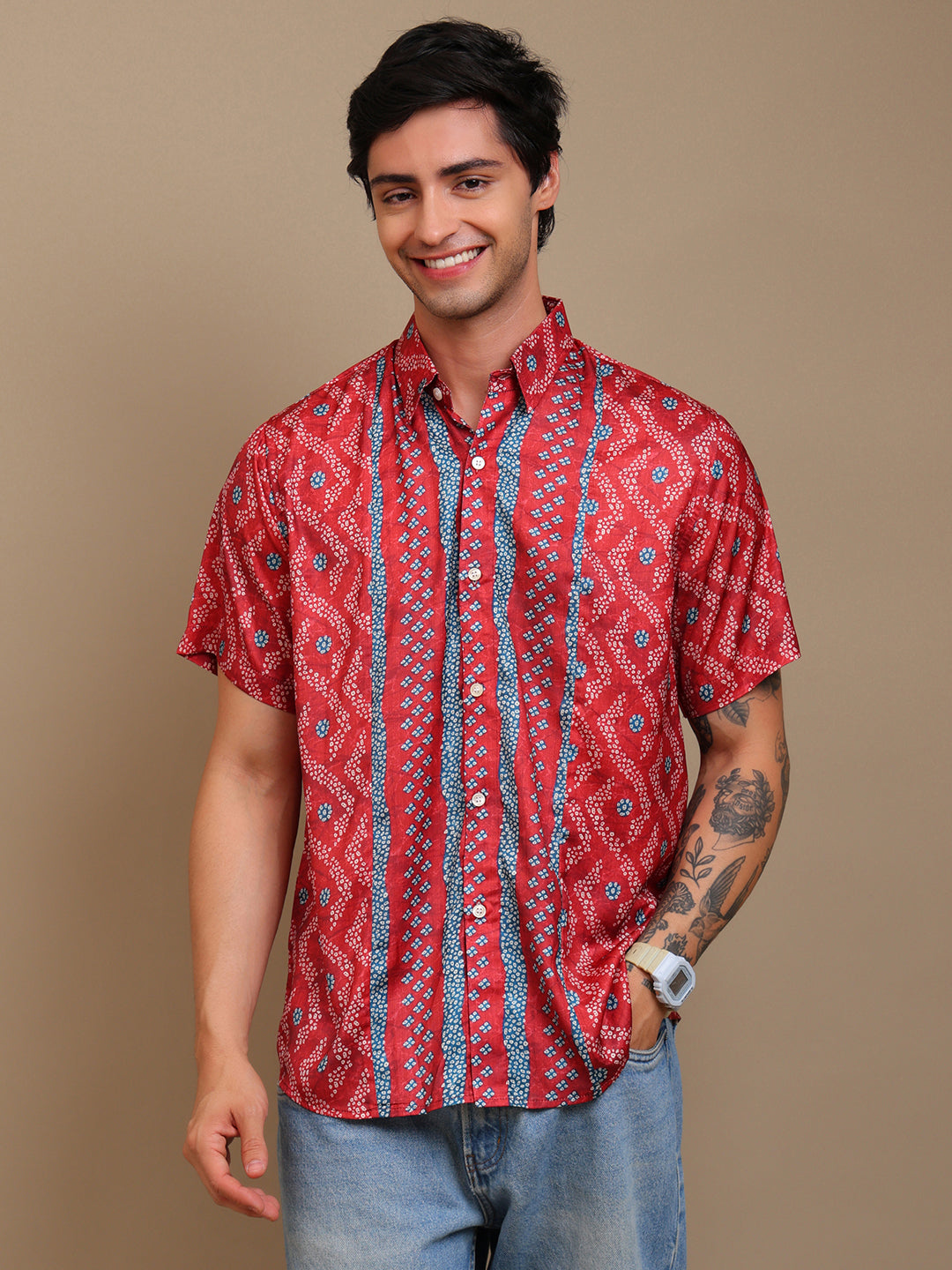 Man wearing a red patterned shirt against a brown background