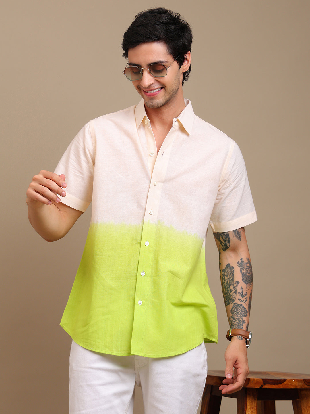 Man wearing a two-tone shirt with a beige top and green bottom on a brown background